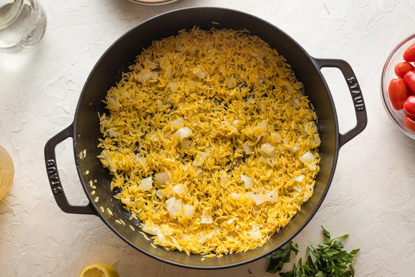 Dried orzo added to skillet.