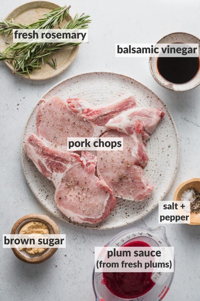 Labeled overhead photo of pork chops on a plate surrounded by prepped bowls of balsamic vinegar, brown sugar, plum sauce, fresh rosemary, kosher salt, and black pepper.