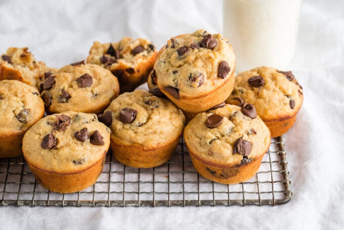 Muffins piled on a cooling rack.
