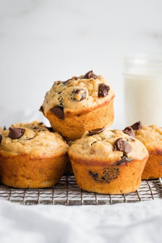 Close-up of banana chocolate chip muffins stacked on a cooling rack.