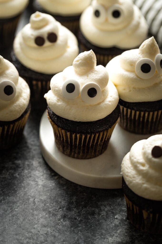 Ghost cupcakes for Halloween decorated with candy eyes.