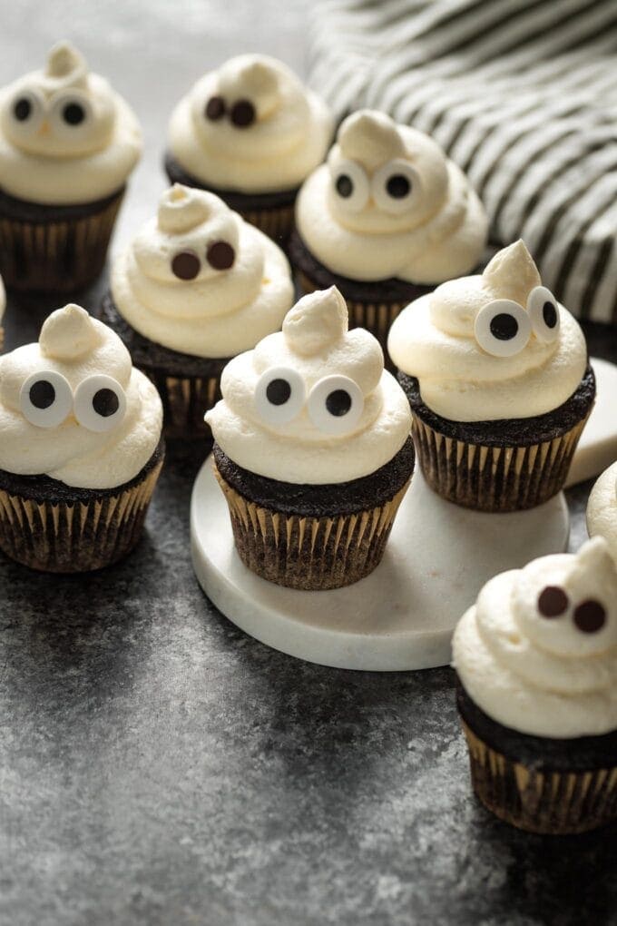 Ghost cupcakes arranged on a black background.