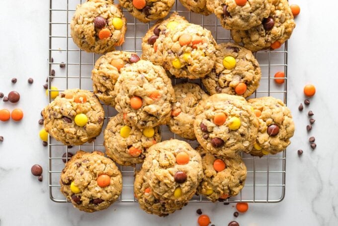 Monster cookies on a cooling rack.