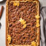 A brown butter slab pecan pie in a pan, baked and ready to serve.