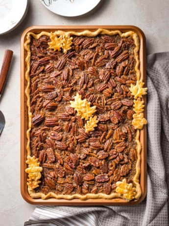 A brown butter slab pecan pie in a pan, baked and ready to serve.