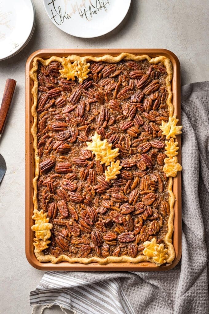 A brown butter slab pecan pie in a pan, baked and ready to serve.