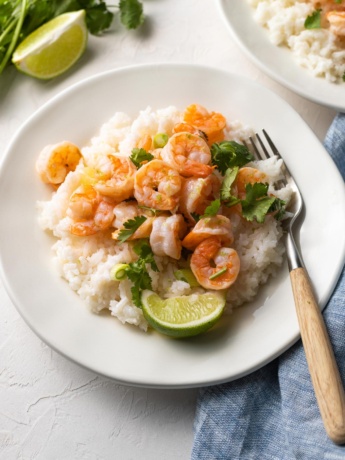 Plate of garlic lime shrimp with coconut rice, ready to eat.