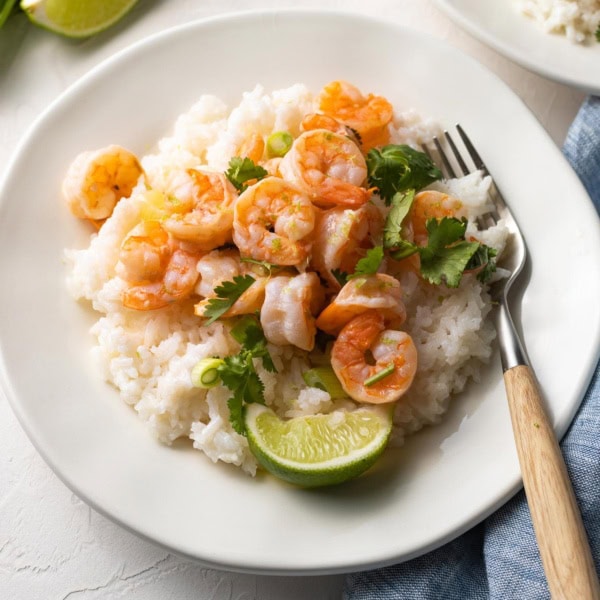 Plate of garlic lime shrimp with coconut rice, ready to eat.