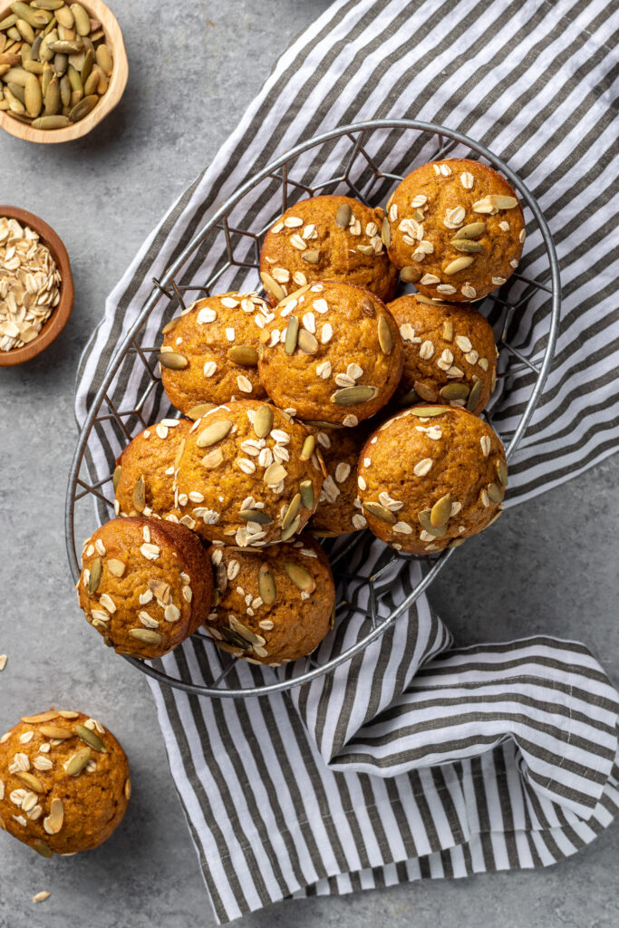 Pumpkin muffins stacked in a basket, ready to share.