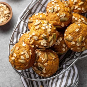 Pumpkin muffins stacked in a basket, ready to share.