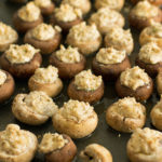 Baking sheet full of stuffed mushrooms just pulled from the oven.