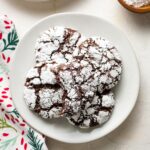 Small white plate filled with chocolate crinkle cookies.