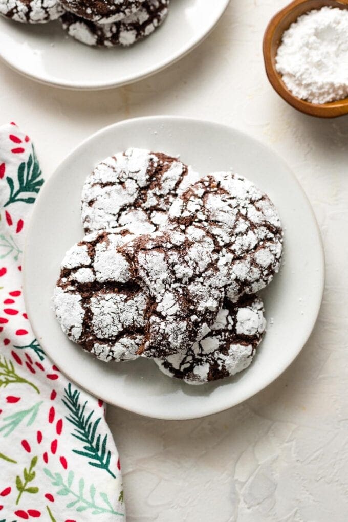 Small white plate filled with chocolate crinkle cookies.