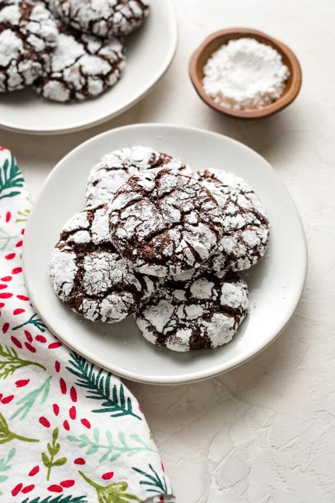 Small plate full of chocolate crinkle cookies.