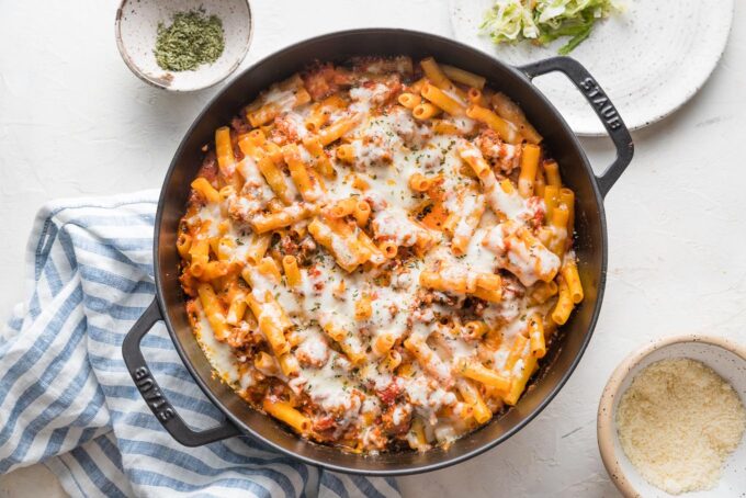 Baked ziti just baked in a skillet with melted mozzarella on top.