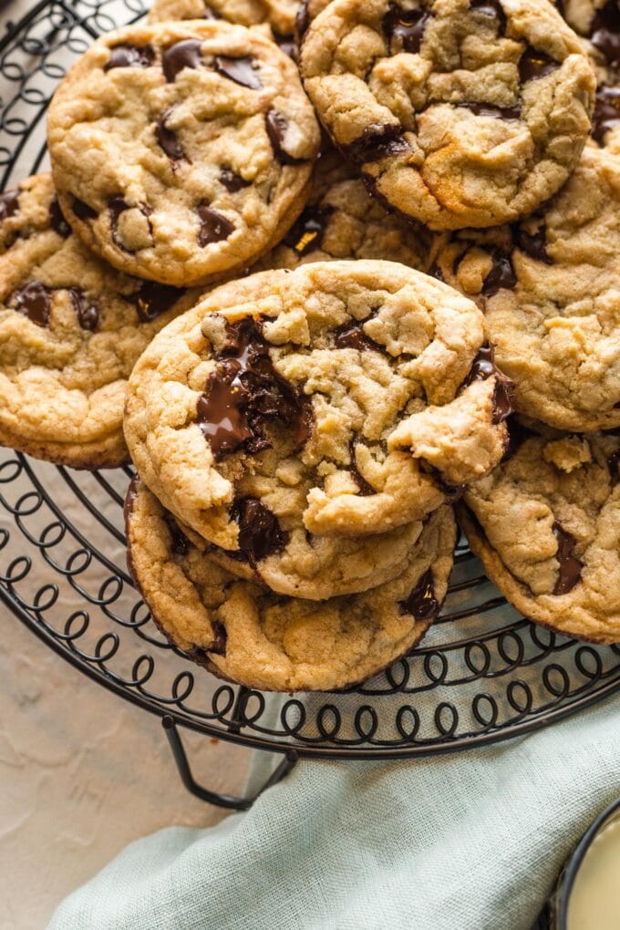 Close up of melted chocolate inside a broken-apart bakery-style chocolate chip cookie.