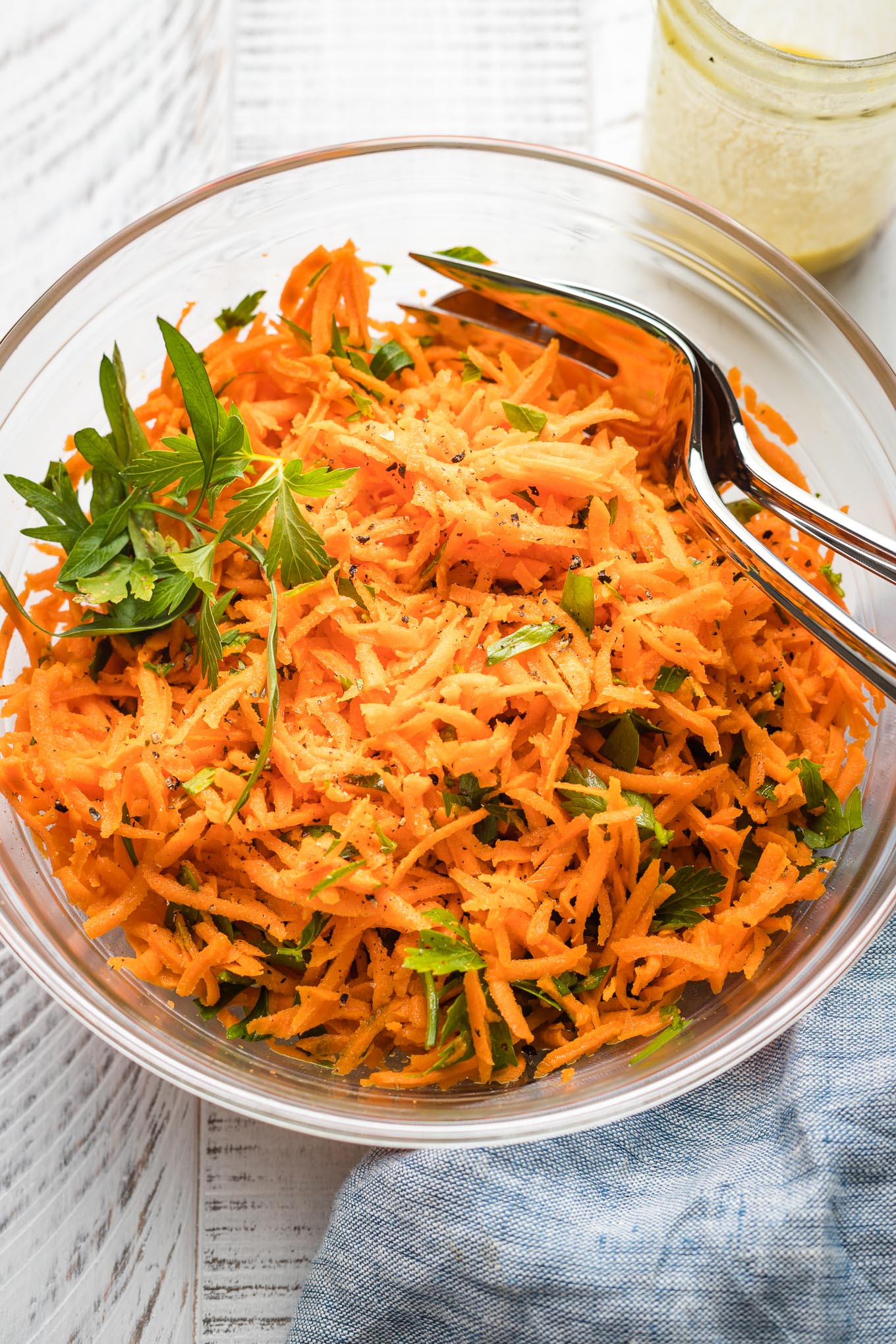 Clear glass bowl holding a French carrot salad.