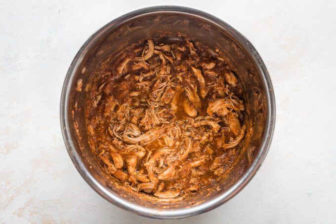 Shredded chicken Tinga in the bowl of an Instant Pot.