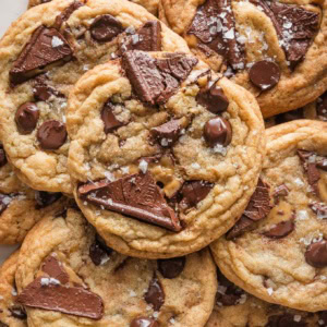 Close up overhead view of a salted caramel chocolate chip cookie with sea salt flaked on top.