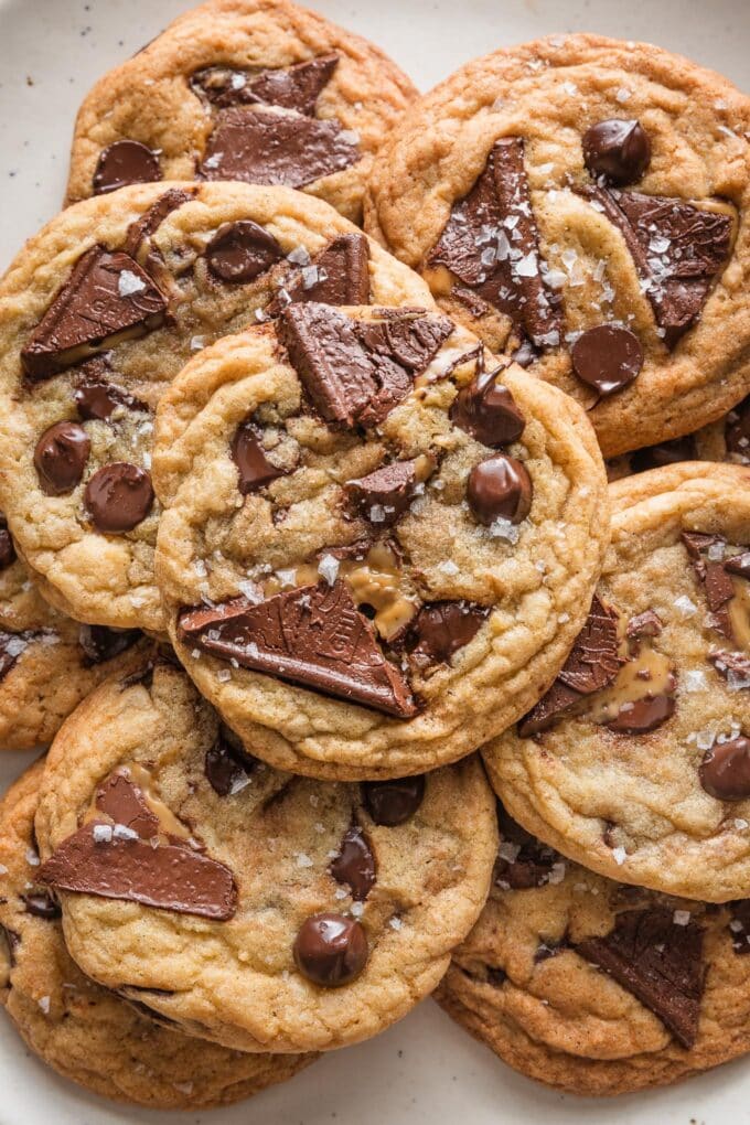 Close up overhead view of a salted caramel chocolate chip cookie with sea salt flaked on top.