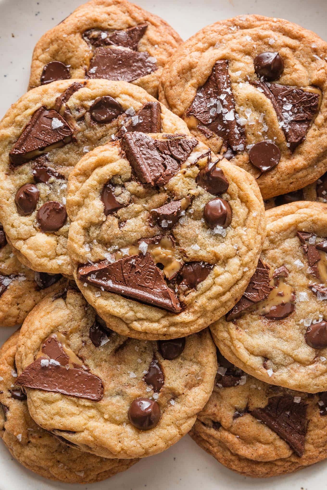 Close up overhead view of a salted caramel chocolate chip cookie with sea salt flaked on top.