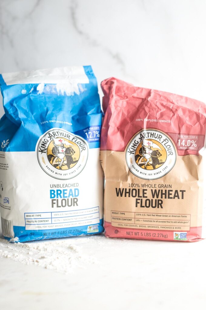 Bags of flour on a kitchen counter - one bread flour and one whole wheat.