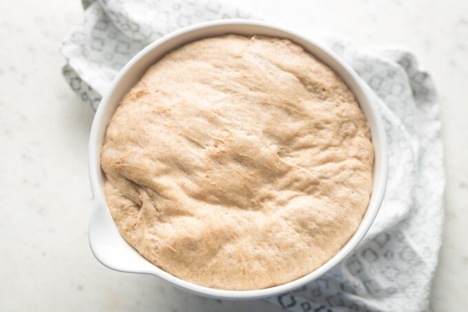 Dough completely risen and filling the entire mixing bowl, now ready to shape, roll, and bake.