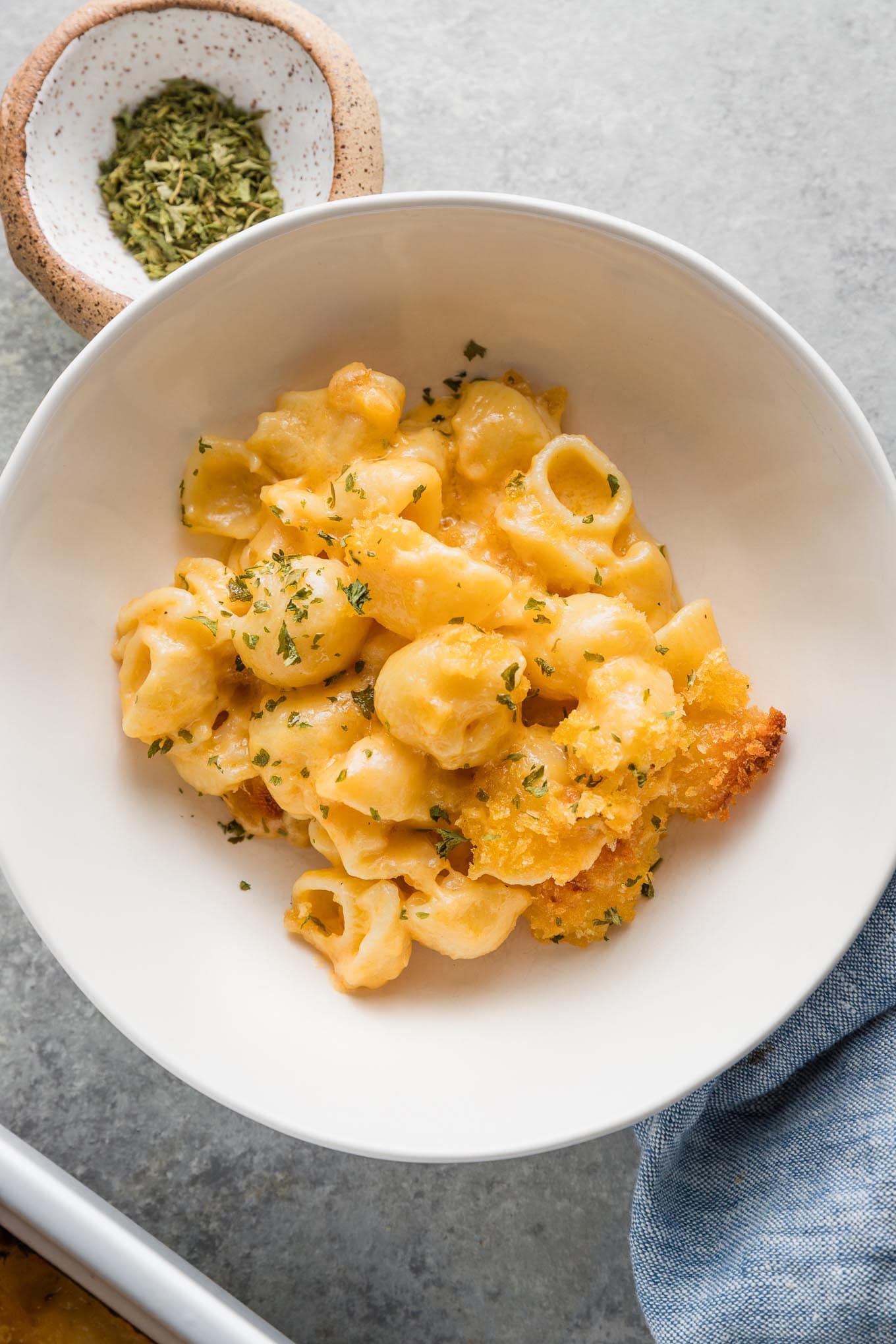 Bowl of creamy baked mac and cheese with breadcrumb topping.