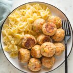 Plate of baked turkey meatballs served with farfalle.