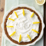 Overhead view of a lemon cream pie with whipped cream topping.