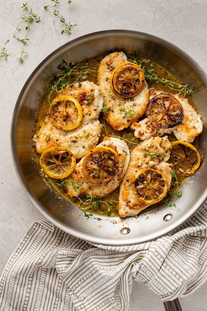 A skillet filled with lemon thyme chicken breasts, a quick and easy weeknight dinner.