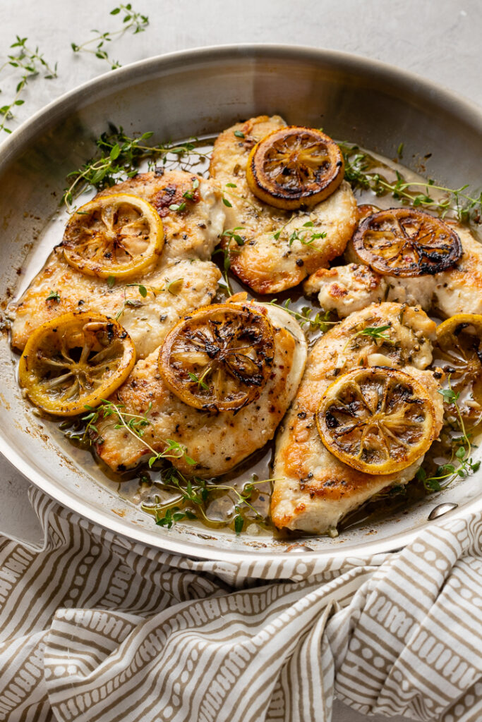 A skillet filled with lemon thyme chicken breasts, a quick and easy weeknight dinner.