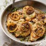 A skillet filled with lemon thyme chicken breasts, a quick and easy weeknight dinner.