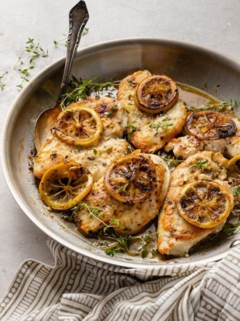 A skillet filled with lemon thyme chicken breasts, a quick and easy weeknight dinner.