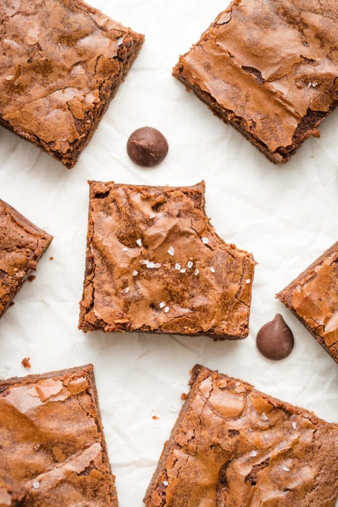 Close up of a chewy brownie with one bite taken out.