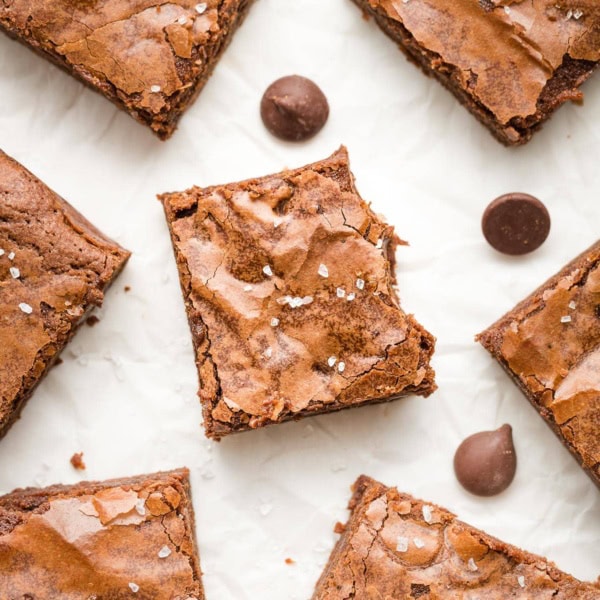 Close-up of a chewy brownie with a thin, crackly top.