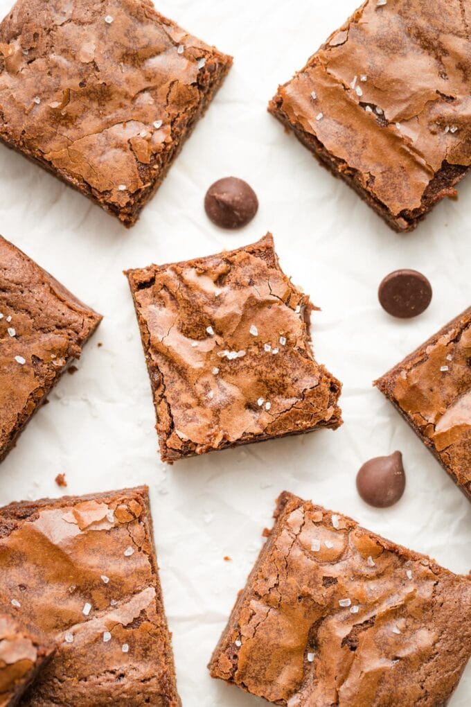 Close-up of a chewy brownie with a thin, crackly top.