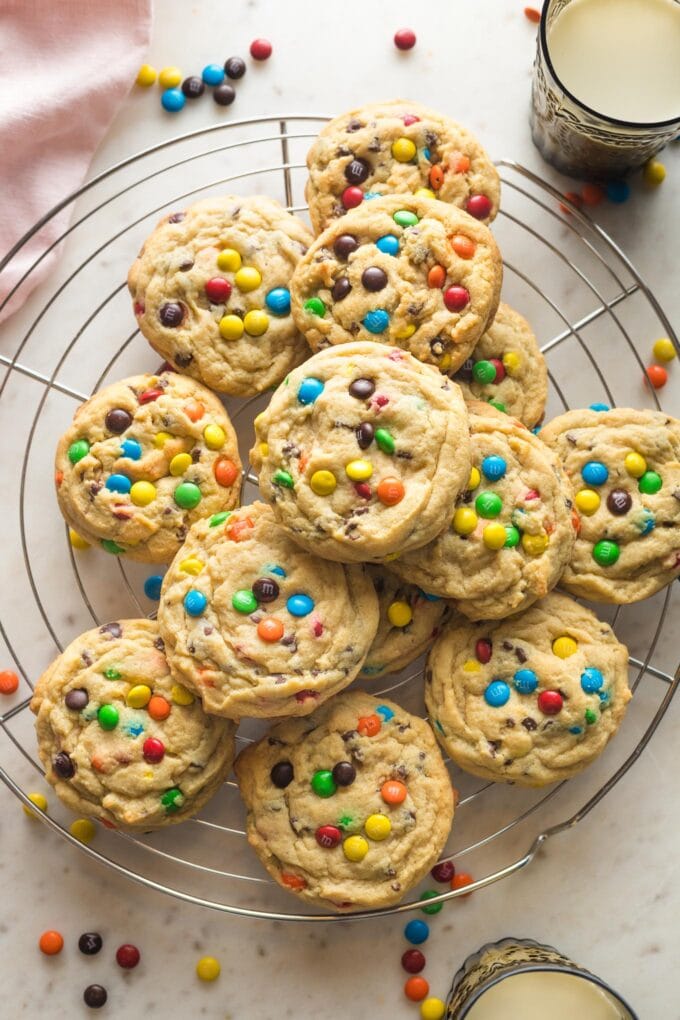 Cooling rack full of chocolate chip M&M cookies.