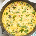 Baked frittata in a white cast-iron pan.