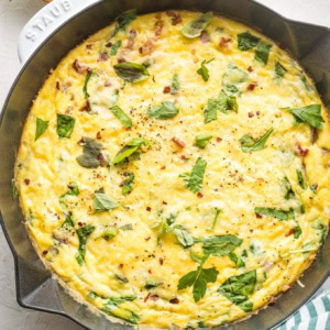 Baked frittata in a white cast-iron pan.