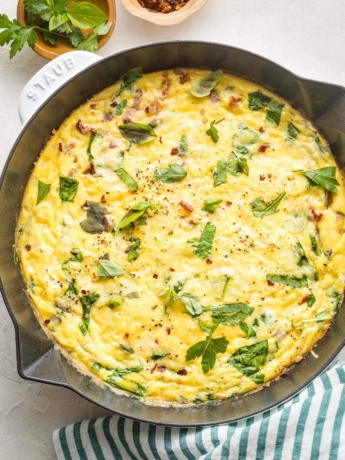 Baked frittata in a white cast-iron pan.