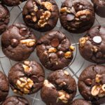 Double chocolate espresso walnut cookies cooling on a silver rack.