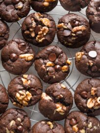 Double chocolate espresso walnut cookies cooling on a silver rack.