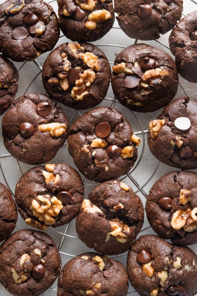 Double chocolate espresso walnut cookies cooling on a silver rack.