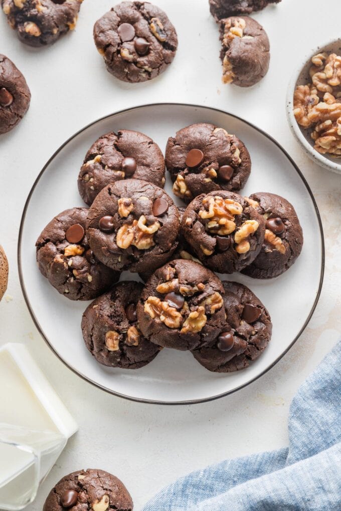 Small plate piled with double chocolate espresso cookies with walnuts.