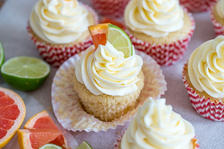 Close-up of a Paloma cupcake with grapefruit and lime slices for garnish.