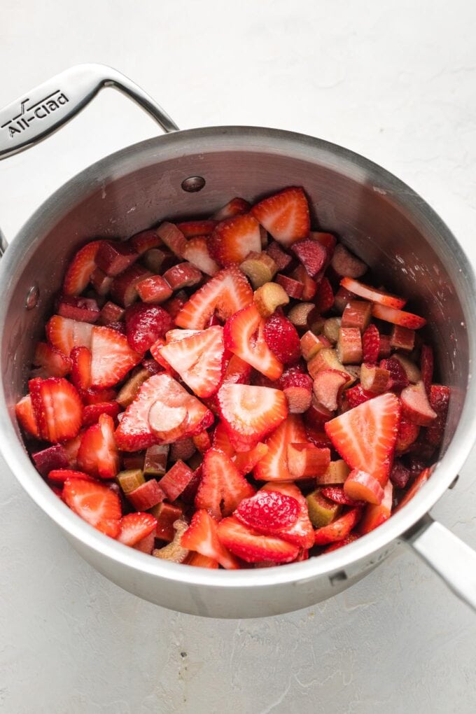 Sliced strawberries and rhubarb in a saucepan.