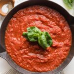 A simple homemade marinara sauce just cooked with fresh basil in the skillet.