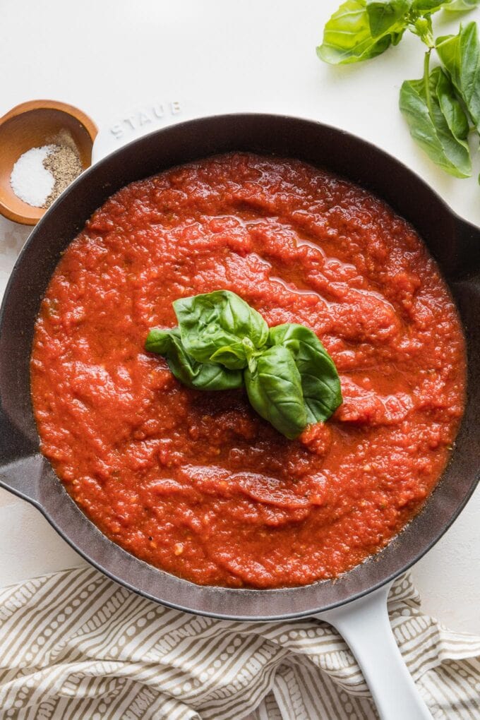 A simple homemade marinara sauce just cooked with fresh basil in the skillet.