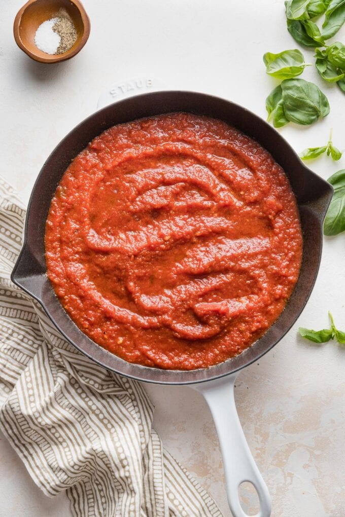 Skillet full of a rich, thick homemade marinara sauce.